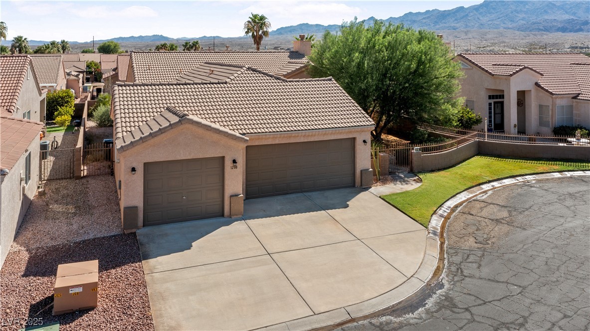 1200 Golf Club Drive Laughlin, NV 89029 - Photo 81 of 87 View of front of property with stucco siding, concrete driveway, a tiled roof, and a mountain view