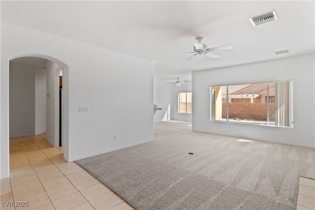 1200 Golf Club Drive Laughlin, NV 89029 - Photo 9 of 87 Carpeted Living room featuring tile patterned floors, ceiling fan, and arched walkways