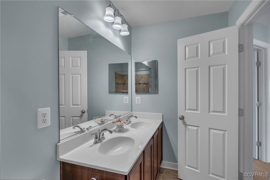 14518 Shipborne Road Midlothian, VA 23112 - Photo 30 of 50 a bathroom with a sink a mirror and a vanity