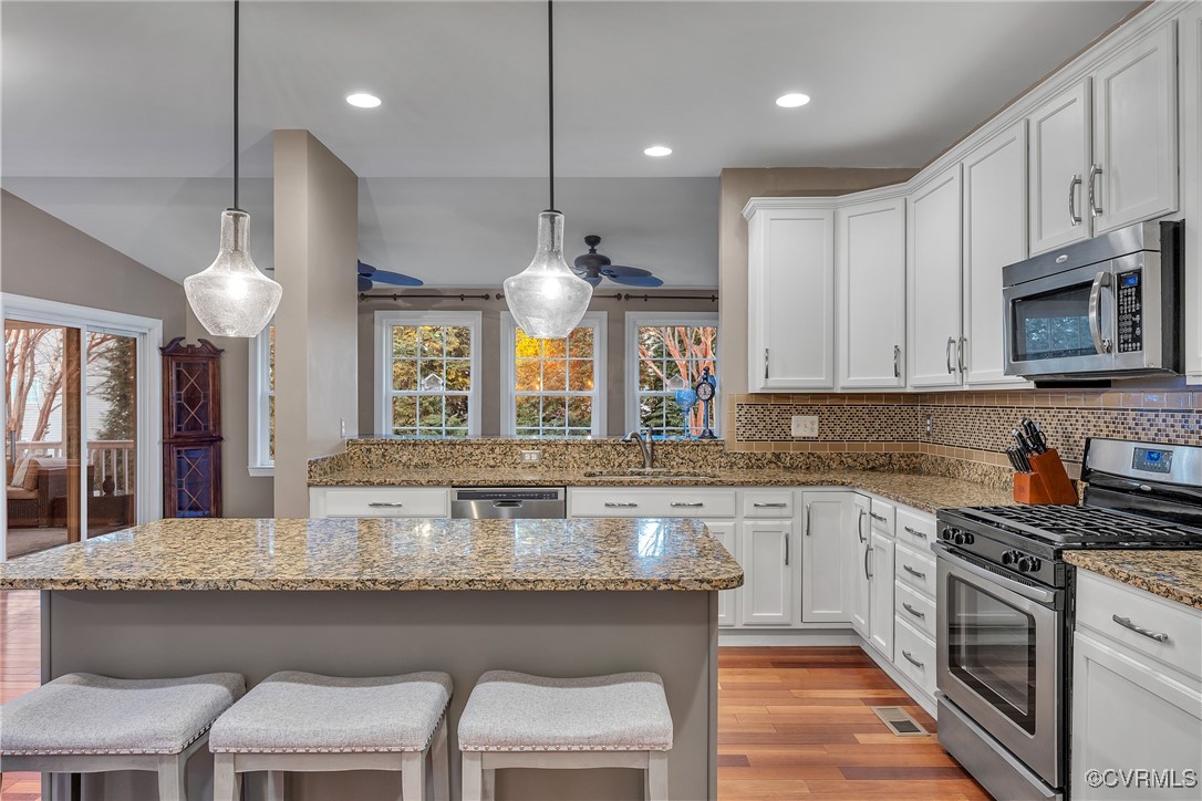14518 Shipborne Road Midlothian, VA 23112 - Photo 9 of 50 a kitchen with kitchen island granite countertop a table chairs sink and cabinets