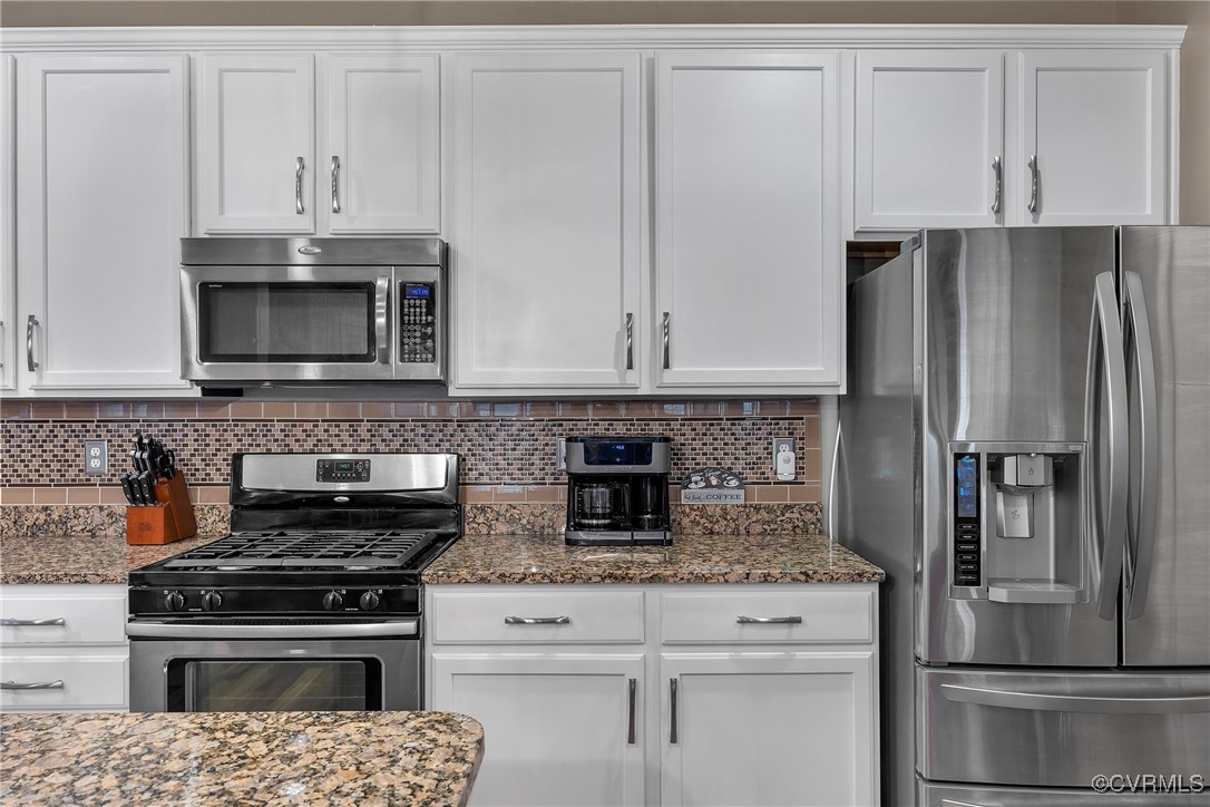 14518 Shipborne Road Midlothian, VA 23112 - Photo 10 of 50 a kitchen with granite countertop white cabinets and stainless steel appliances