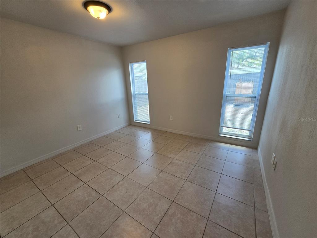 3406 Murrow Street New Port Richey, FL 34655 - Photo 9 of 21 an empty room with windows and entrance