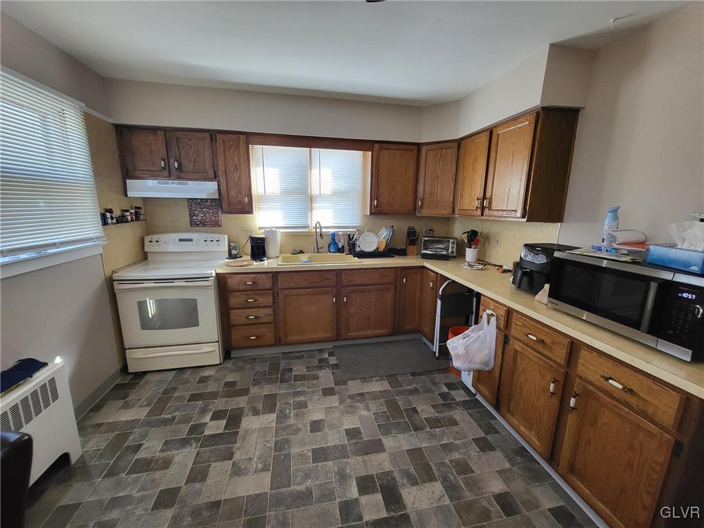 637 5th Street Whitehall, PA 18052 - Photo 16 of 25 a kitchen with a sink a stove and cabinets