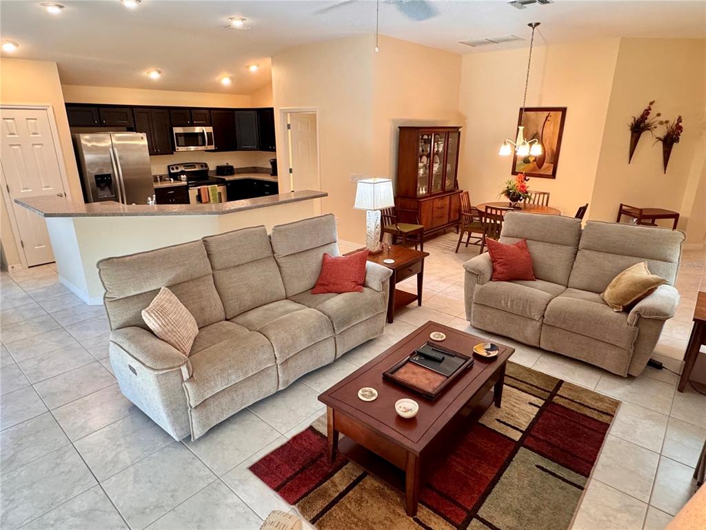 2184 Markridge Loop The Villages, FL 32162 - Photo 14 of 35 a living room with furniture a flat screen tv and a couch
