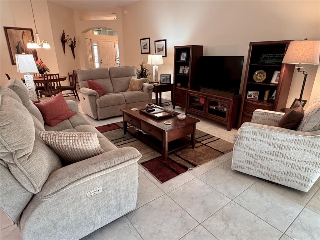 2184 Markridge Loop The Villages, FL 32162 - Photo 15 of 35 a living room with furniture and a flat screen tv