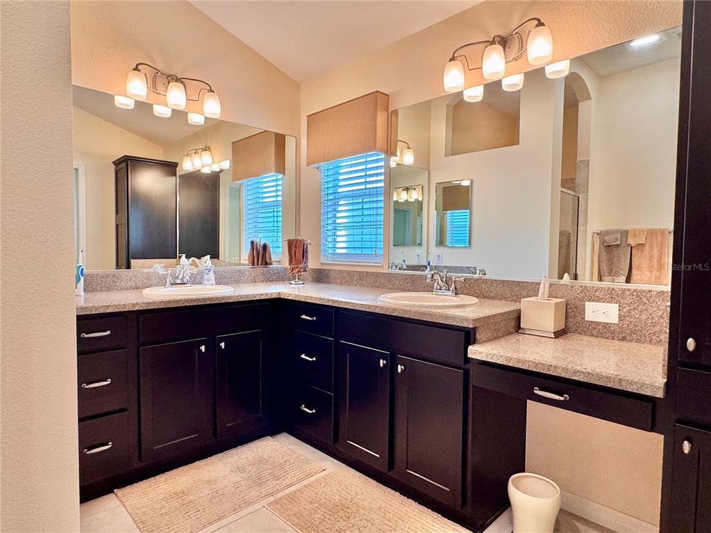 2184 Markridge Loop The Villages, FL 32162 - Photo 23 of 35 a bathroom with a granite countertop sink and a large mirror