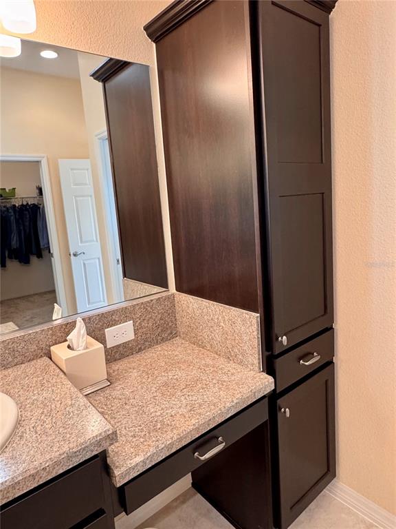 2184 Markridge Loop The Villages, FL 32162 - Photo 24 of 35 a bathroom with a granite countertop sink and a mirror