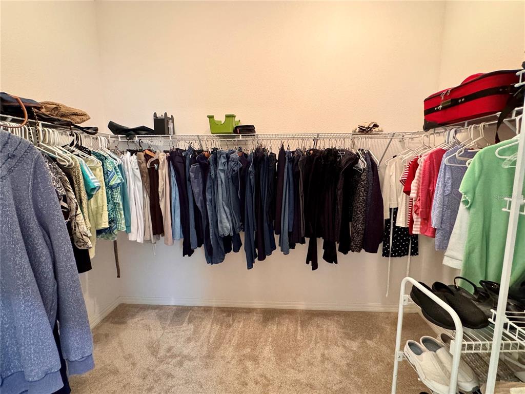 2184 Markridge Loop The Villages, FL 32162 - Photo 25 of 35 a view of walk in closet with clothes and shoes