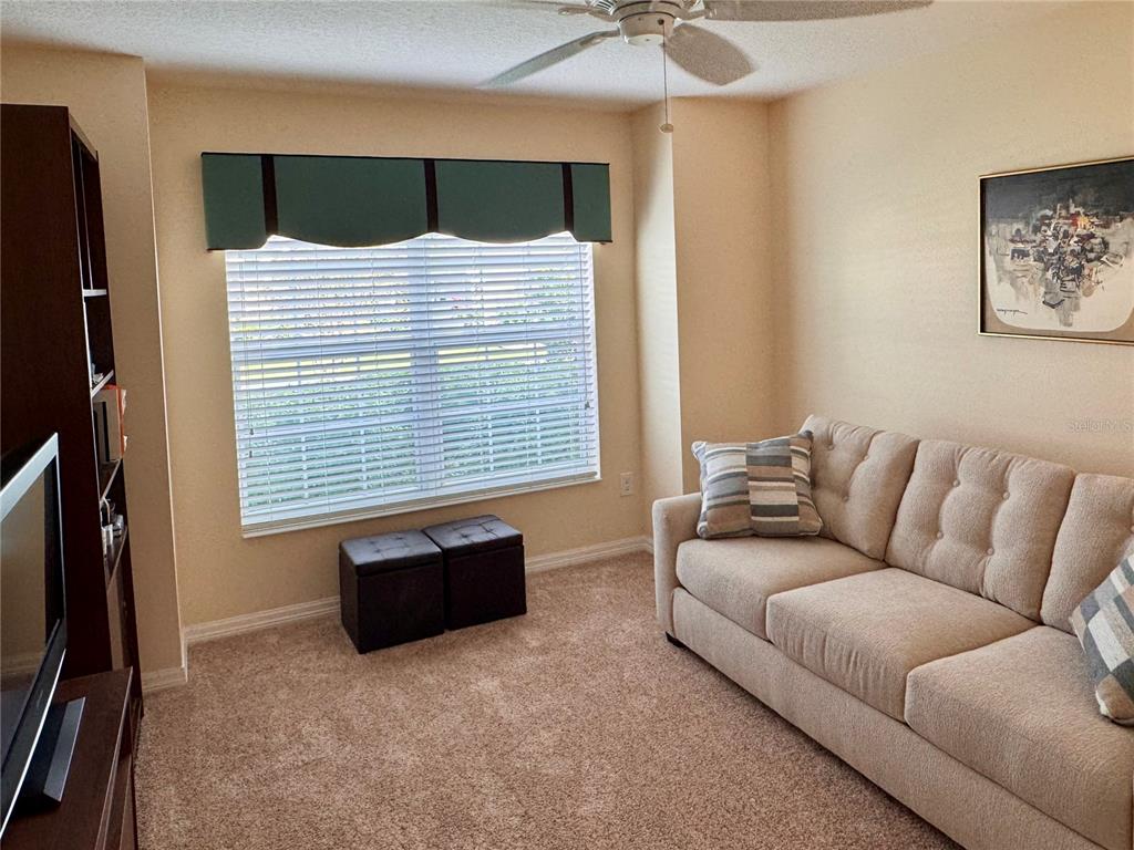 2184 Markridge Loop The Villages, FL 32162 - Photo 29 of 35 a living room with furniture and a flat screen tv