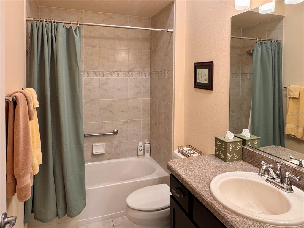 2184 Markridge Loop The Villages, FL 32162 - Photo 32 of 35 a bathroom with a granite countertop sink toilet and shower