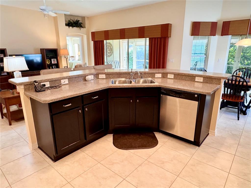 2184 Markridge Loop The Villages, FL 32162 - Photo 7 of 35 a kitchen with a sink stove and cabinets