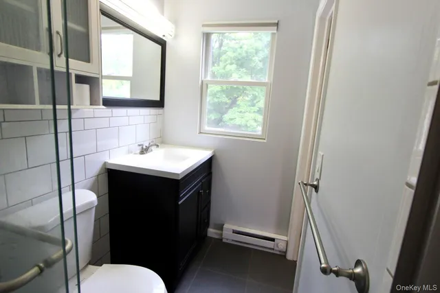 a bathroom with a sink toilet and a mirror
