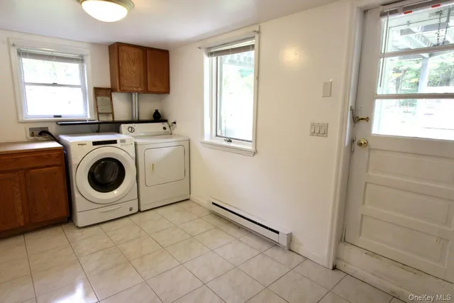 a utility room with sink dryer and washer
