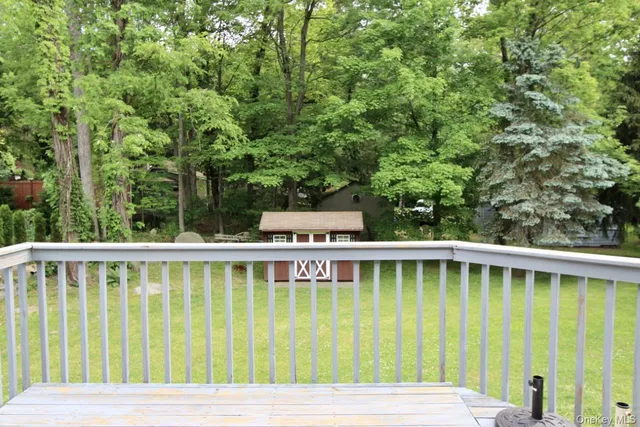 a view of a wooden chairs and swimming pool