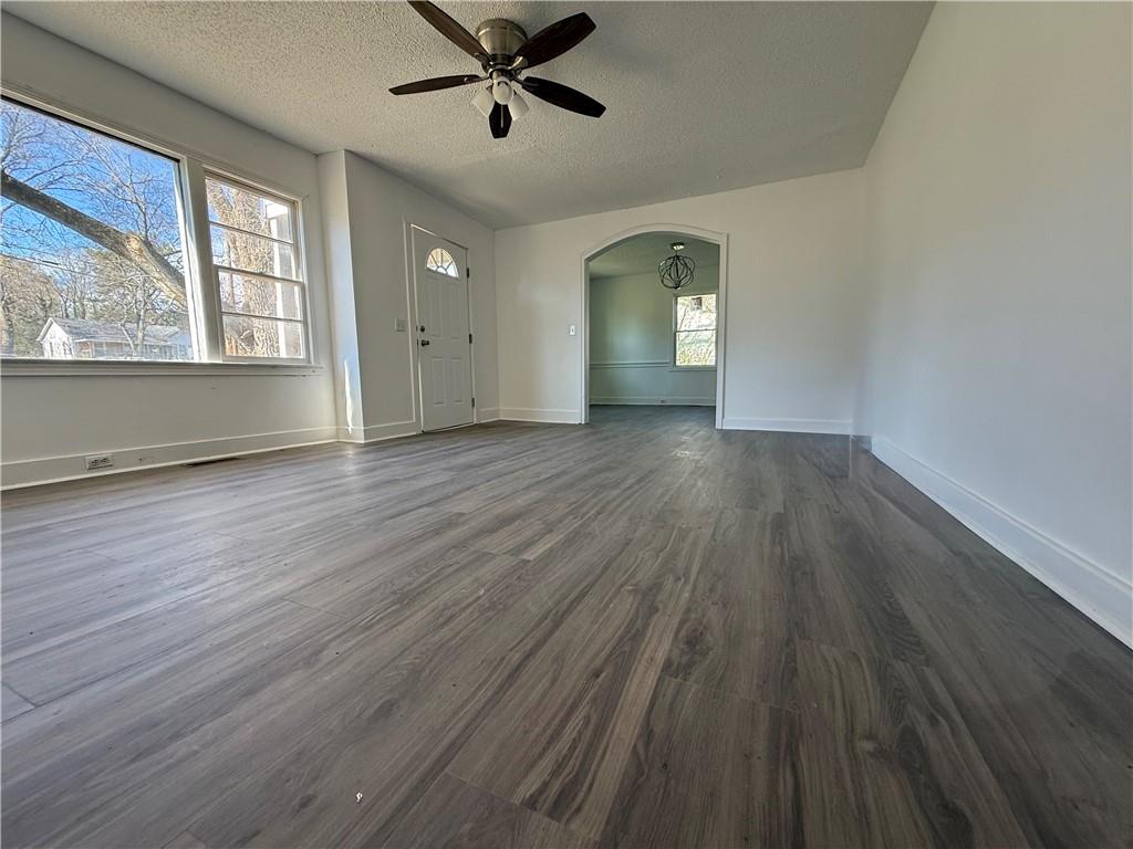 1325 Highway 41 Calhoun, GA 30701 - Photo 4 of 19 an empty room with wooden floor fan and windows