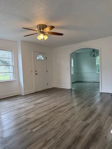 wooden floor in an empty room with a window
