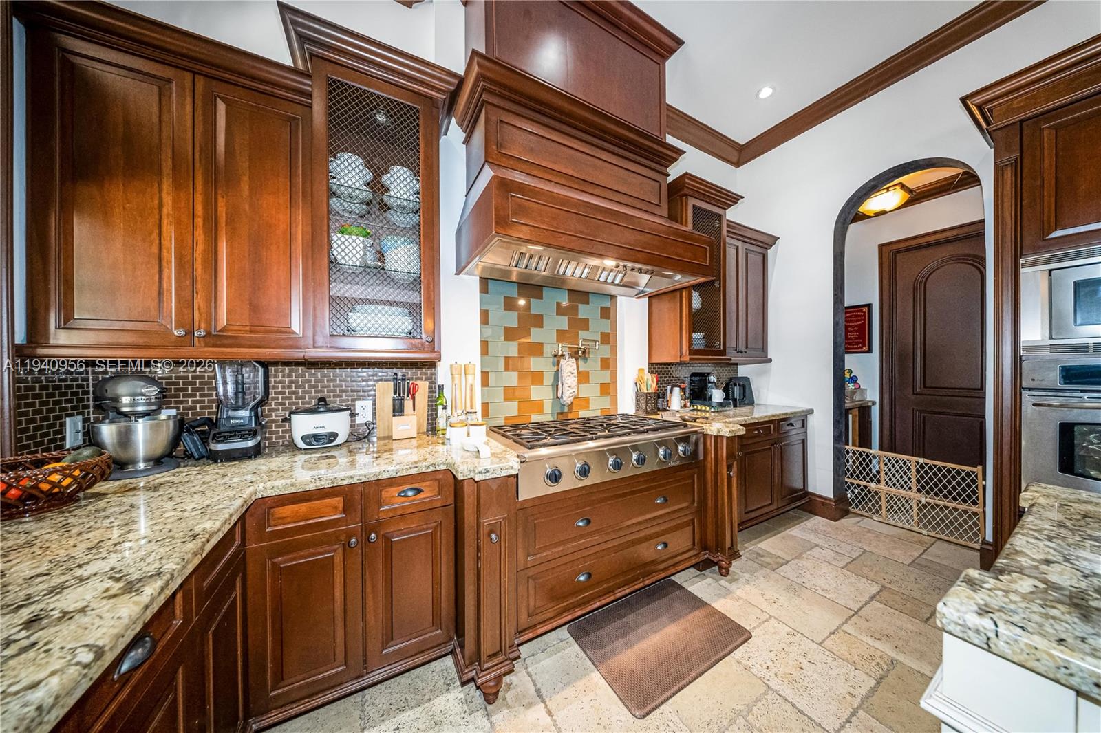 7538 Southwest 64th Street Miami, FL 33143 - Photo 18 of 78 a kitchen with stainless steel appliances granite countertop a sink stove and cabinets