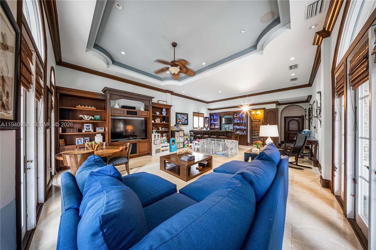 7538 Southwest 64th Street Miami, FL 33143 - Photo 27 of 78 a living room with furniture a fireplace and a chandelier