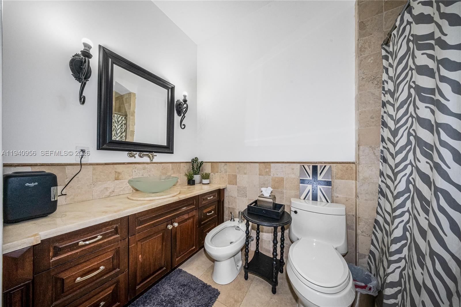 7538 Southwest 64th Street Miami, FL 33143 - Photo 44 of 78 a bathroom with a toilet a sink and mirror