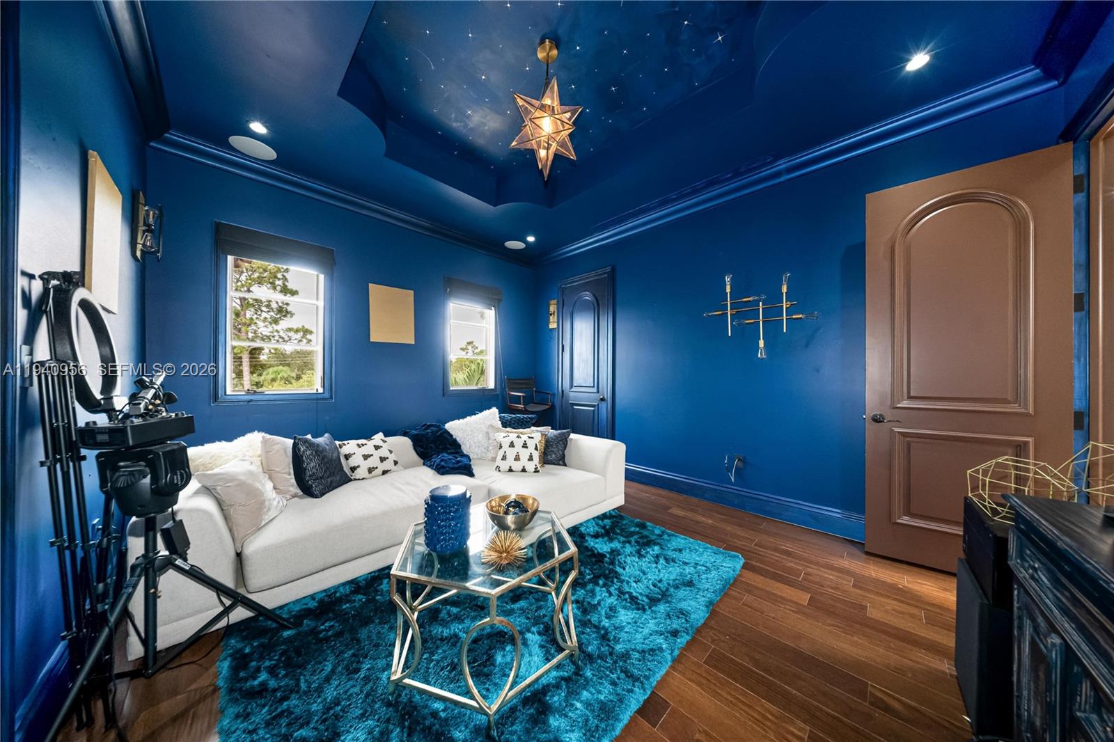 7538 Southwest 64th Street Miami, FL 33143 - Photo 51 of 78 a living room with furniture a fireplace and a chandelier