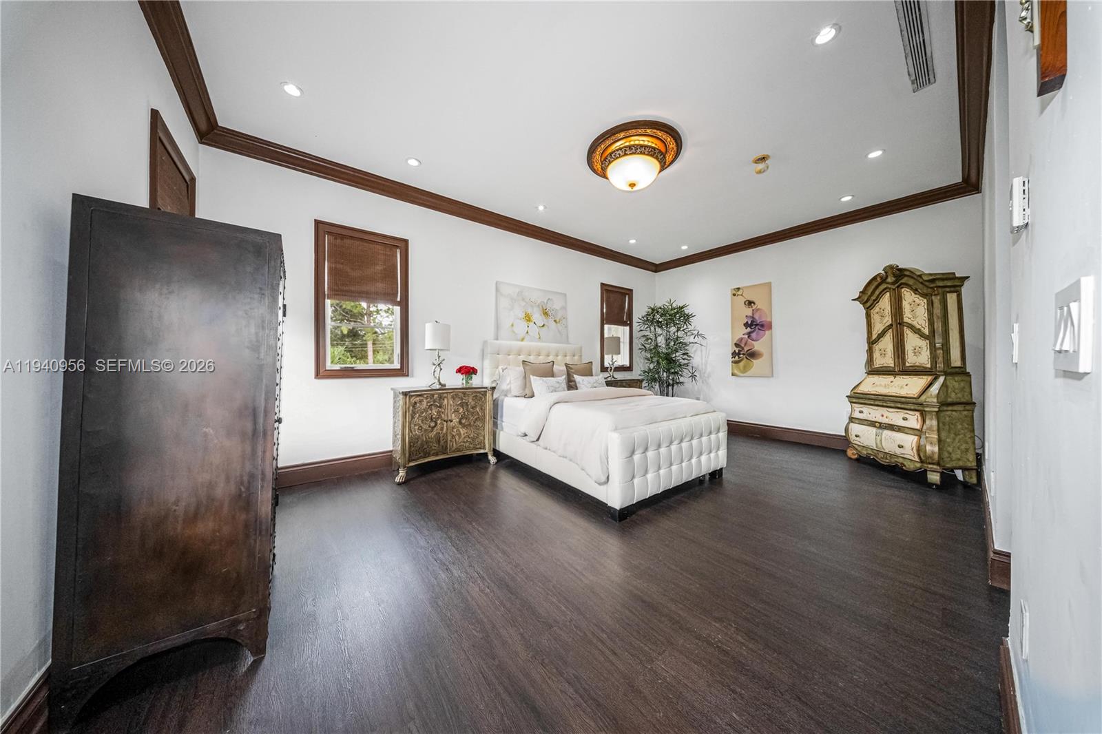 7538 Southwest 64th Street Miami, FL 33143 - Photo 57 of 78 a bedroom with a bed and a chandelier