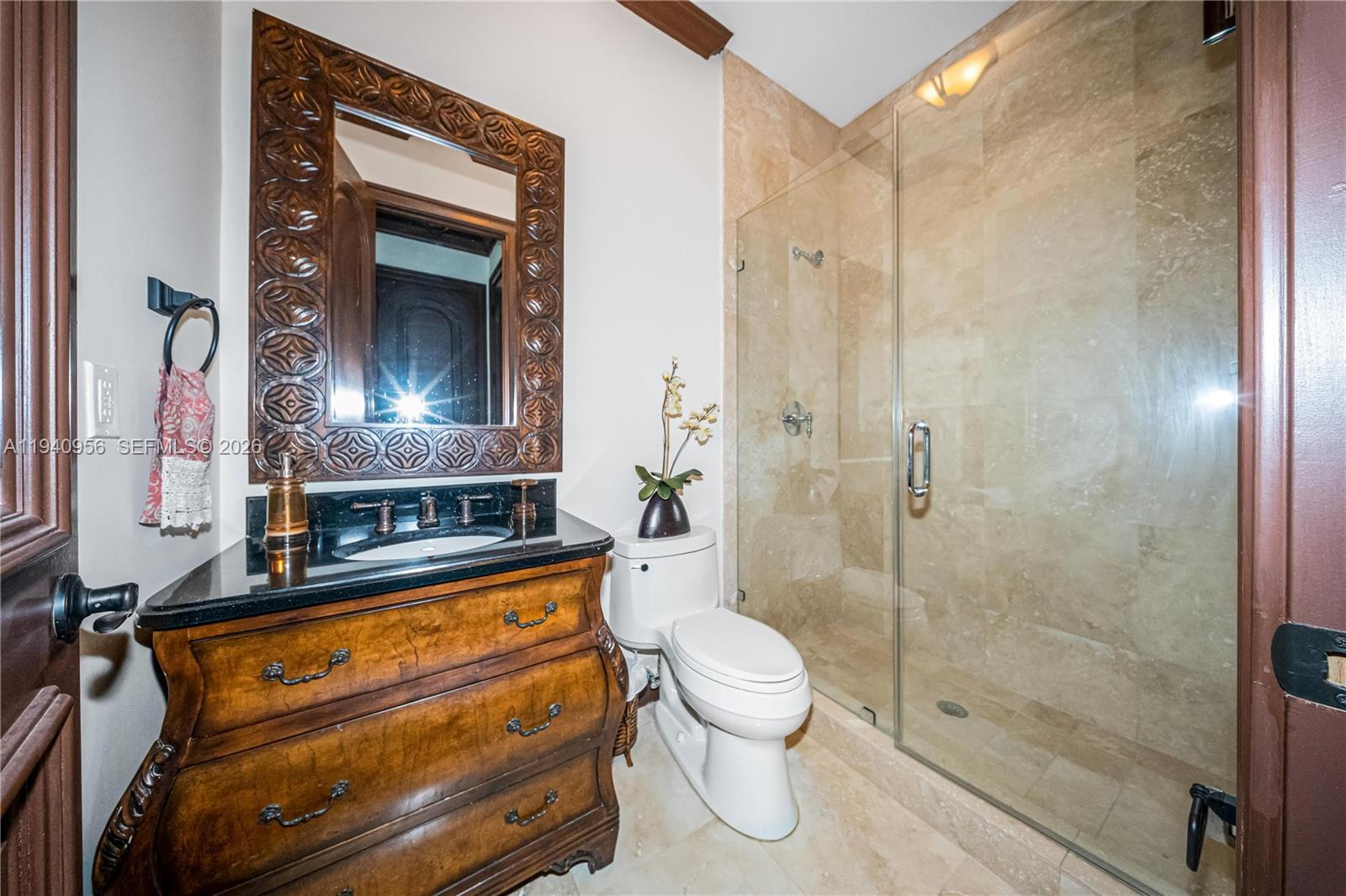 7538 Southwest 64th Street Miami, FL 33143 - Photo 62 of 78 a bathroom with a granite countertop bathtub shower sink mirror and toilet
