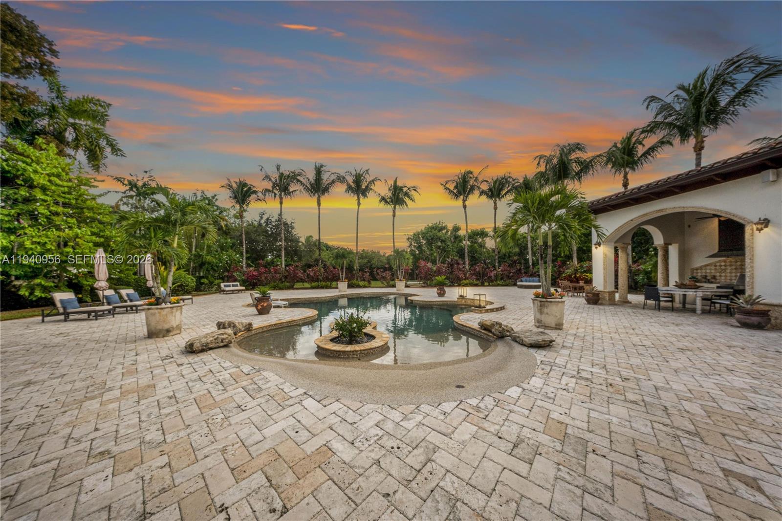 7538 Southwest 64th Street Miami, FL 33143 - Photo 68 of 78 a view of a patio with couches and chairs under an umbrella
