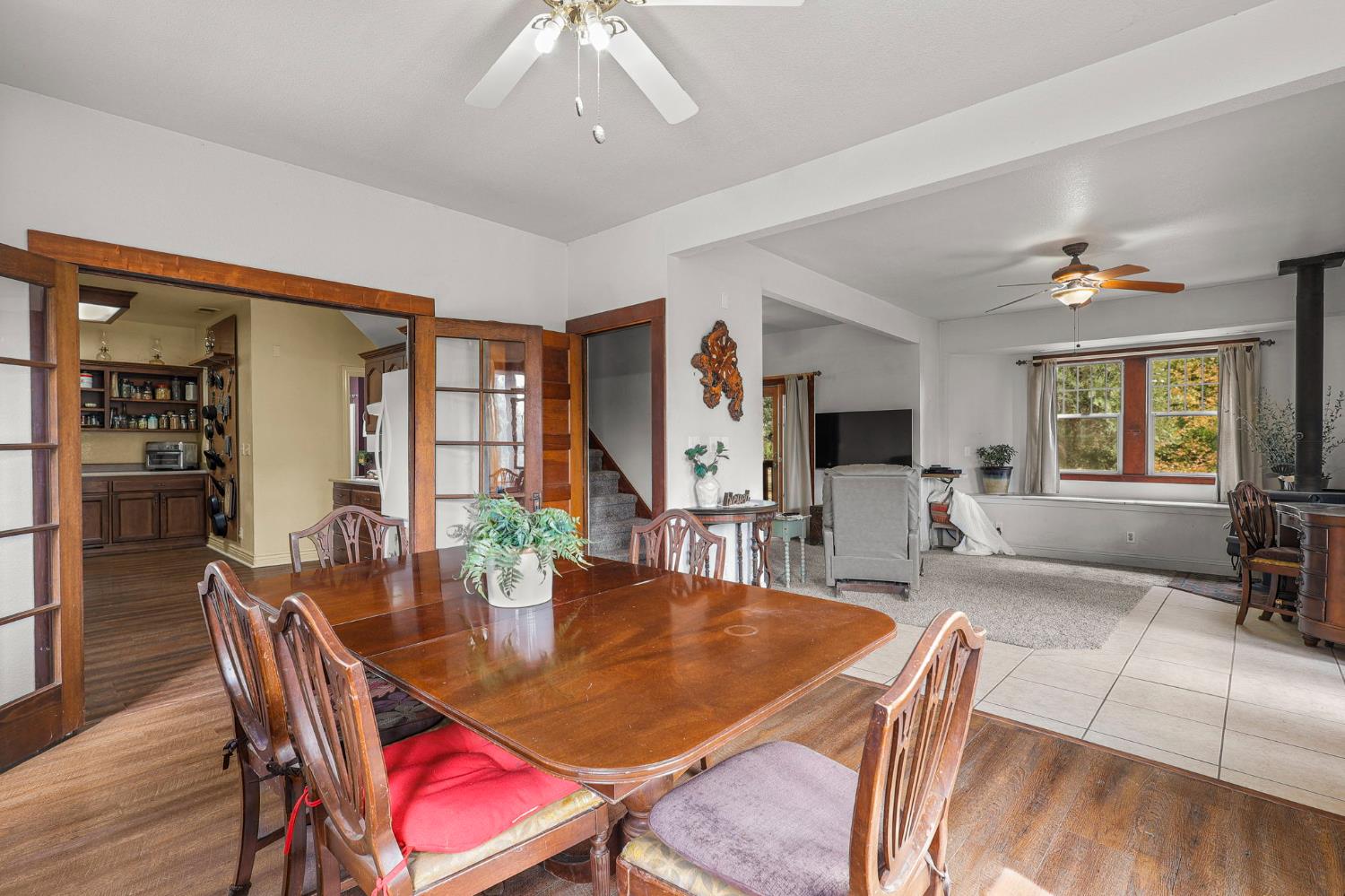 18525 Emerson Road Red Bluff, CA 96080 - Photo 13 of 92 a dining room with furniture a rug a potted plant and wooden floor