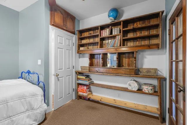 a view of an empty room with a fireplace and a window