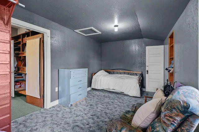 a bed room with a bed and a rug