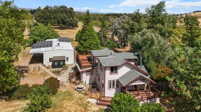 an aerial view of a house with a yard