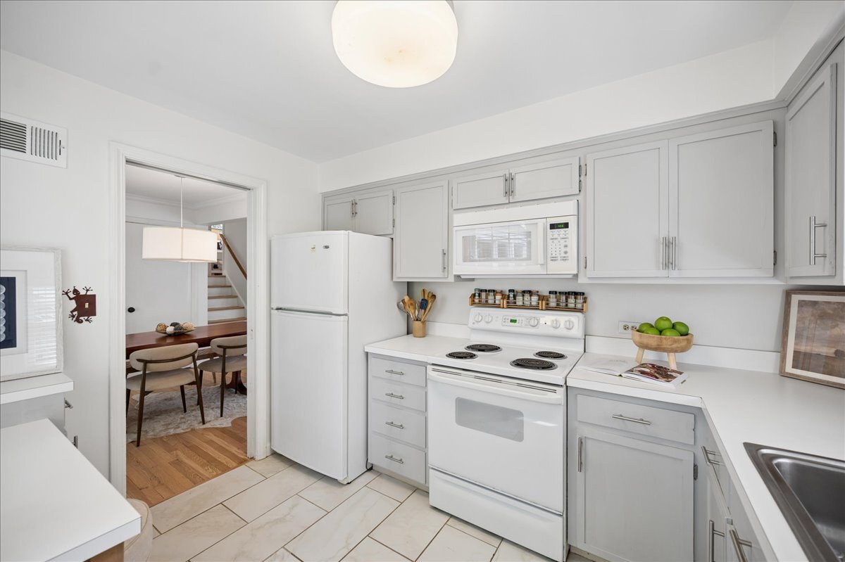 712 Juniper Road Glenview, IL 60025 - Photo 13 of 33 a kitchen with white cabinets and white appliances