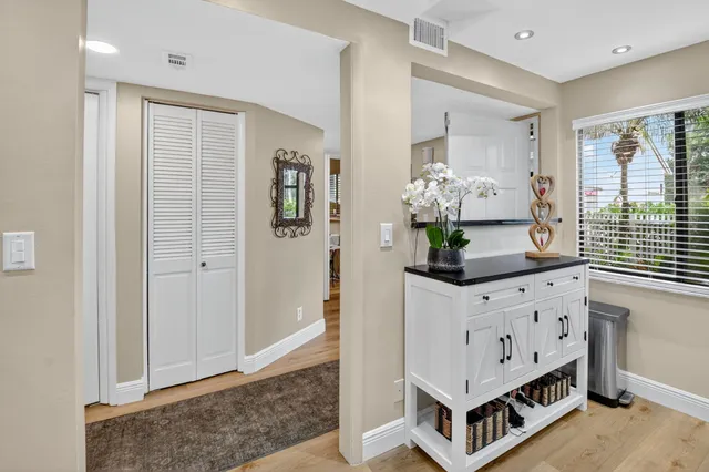 a living room with stainless steel appliances kitchen island granite countertop furniture and a window