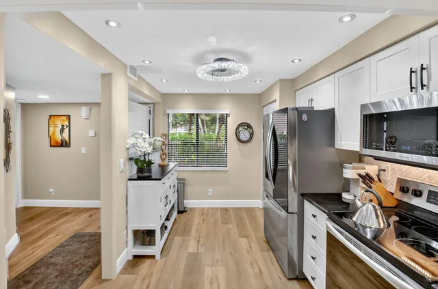 a view of a dining room with furniture wooden floor and a chandelier
