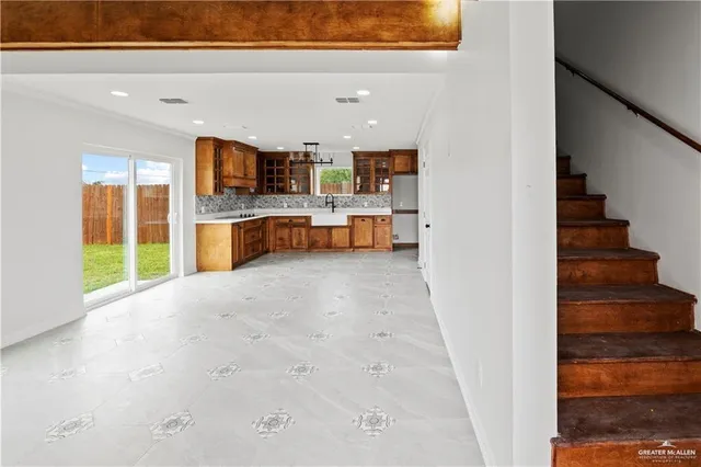 a view of kitchen and hall with wooden floor