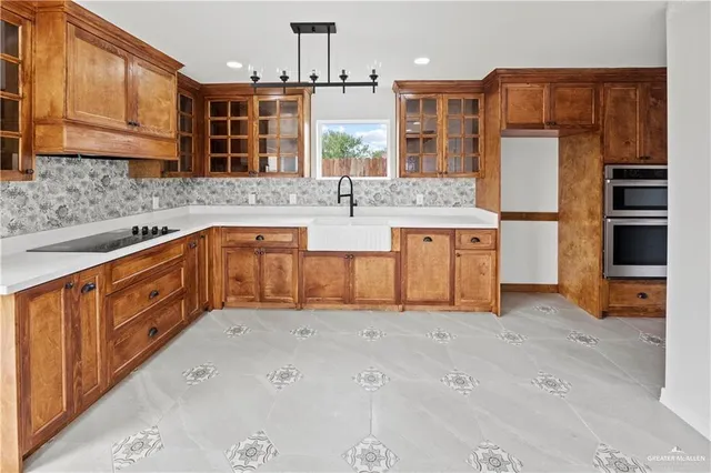 a large kitchen with stainless steel appliances granite countertop a sink and cabinets