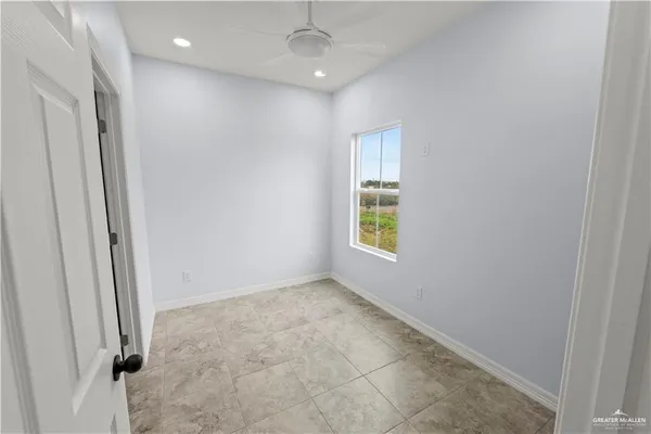 an empty room with windows and closet