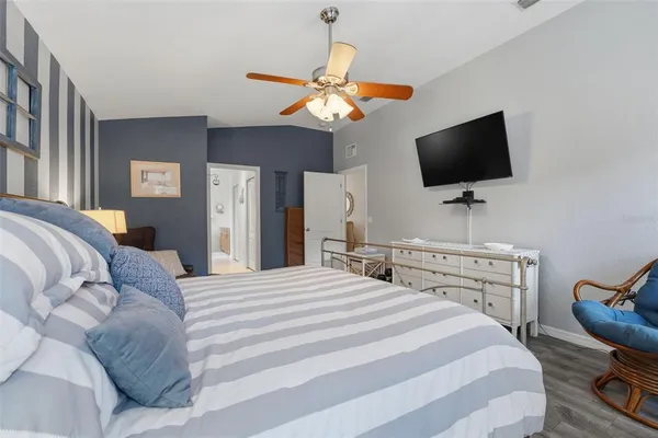 a bedroom with furniture and a flat screen tv