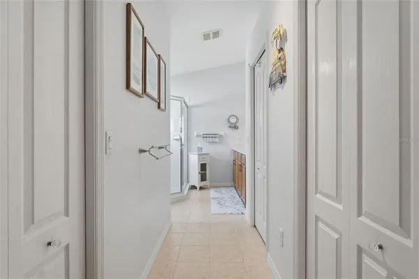 a spacious bathroom with a double vanity sink a mirror and shower