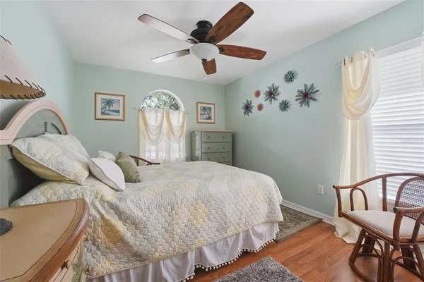 a bedroom with a bed a table and chair