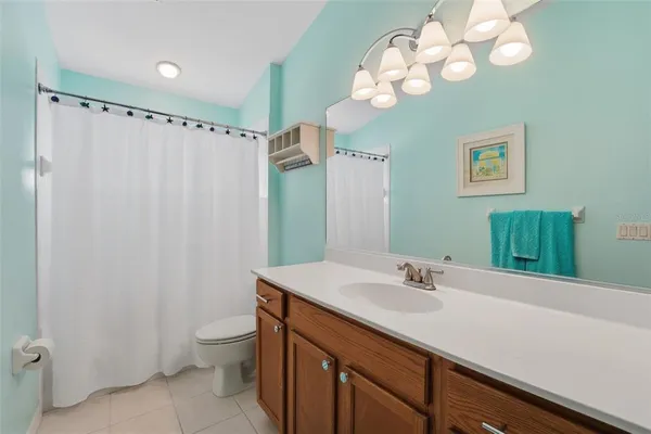 a spacious bedroom with a bed and cabinets