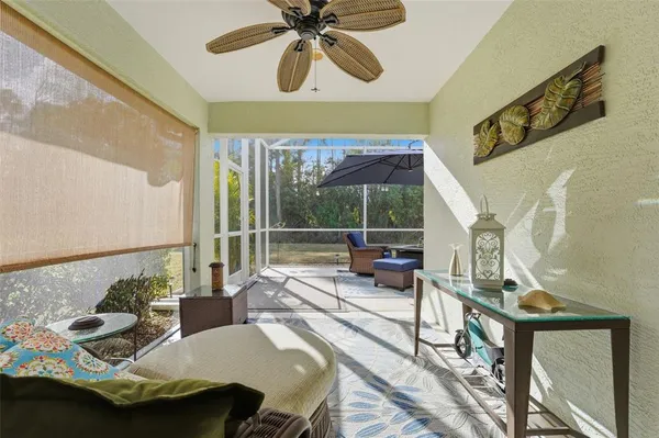 a balcony with furniture and umbrella