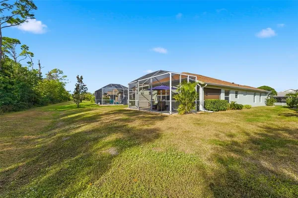 a front view of a house with swimming pool having outdoor seating