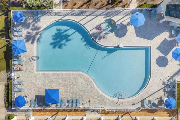 a view of a house with swimming pool and a yard