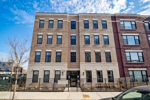 a front view of a residential apartment building with a yard