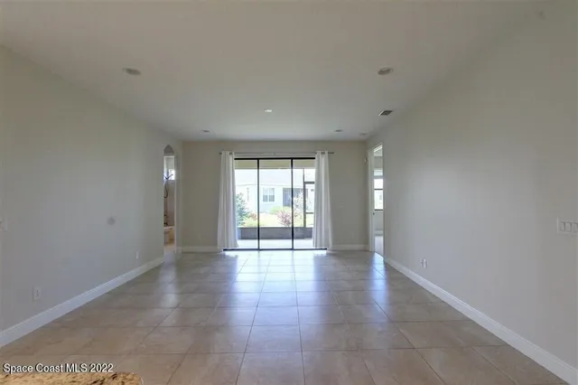 a view of an empty room with glass door