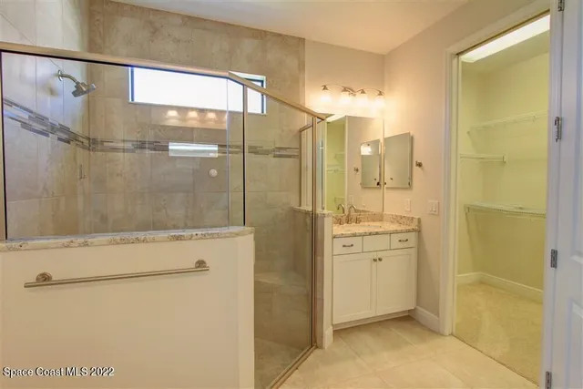 a bathroom with a shower and a sink
