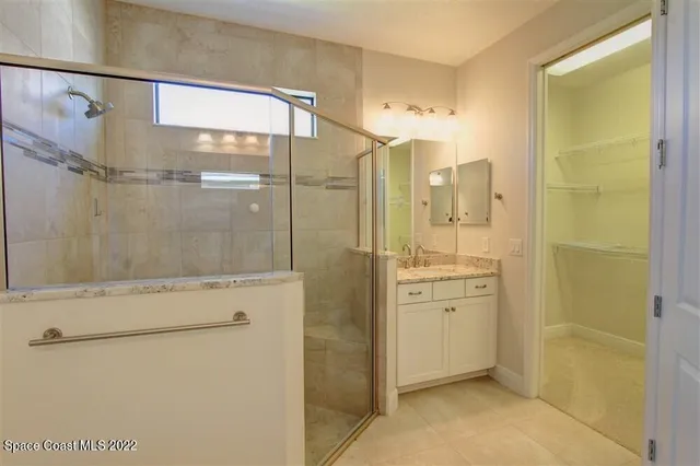 a bathroom with a shower and a sink