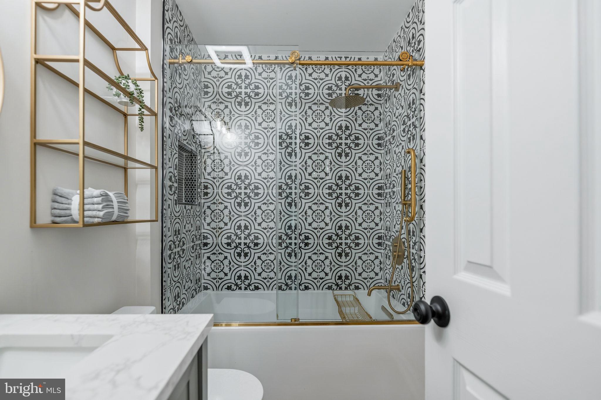 7603 Modisto Lane Springfield, VA 22153 - Photo 33 of 57 a bathroom with a bathtub and shower