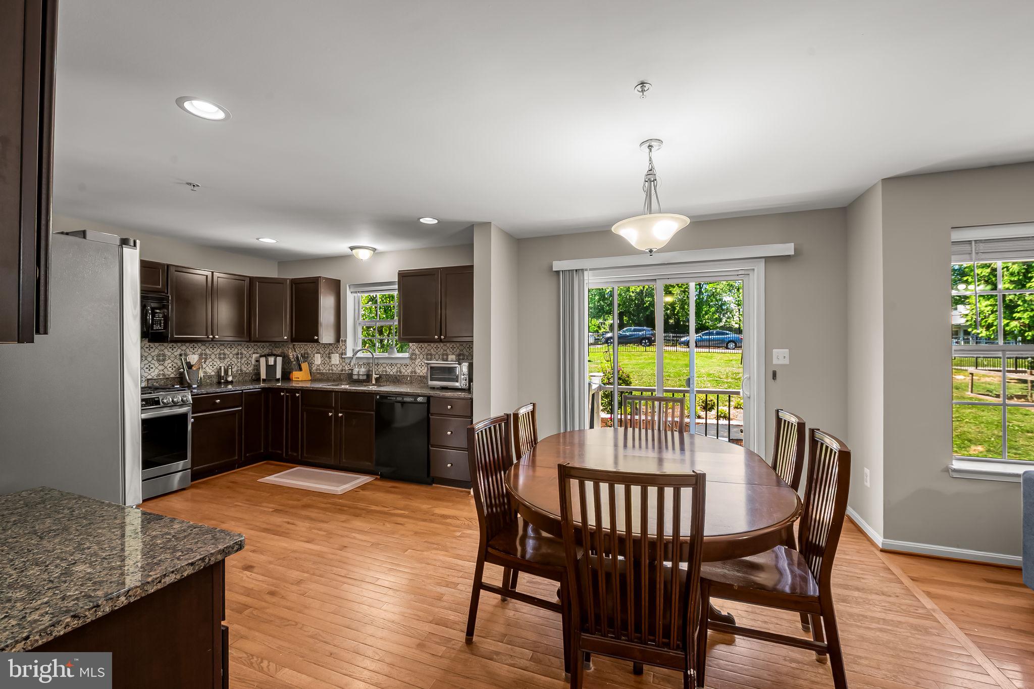 6008 Hanover Road Elkridge, MD 21075 - Photo 9 of 36 a kitchen with granite countertop kitchen island dining table and stainless steel appliances